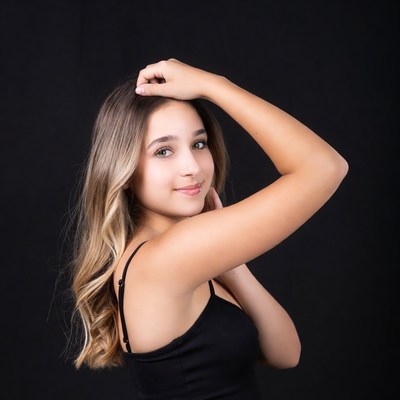 Teen girl posing hand on head