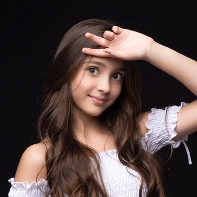 Girl saluting with hand on forehead