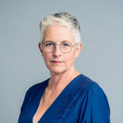 Elderly woman in blue dress with glasses