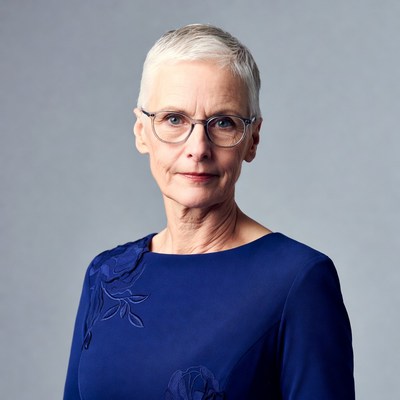 Elderly woman in blue dress with glasses