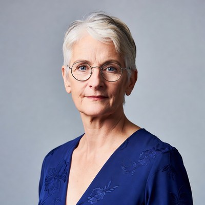 Elderly woman with short white hair and glasses