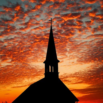 Church silhouette against sunset sky