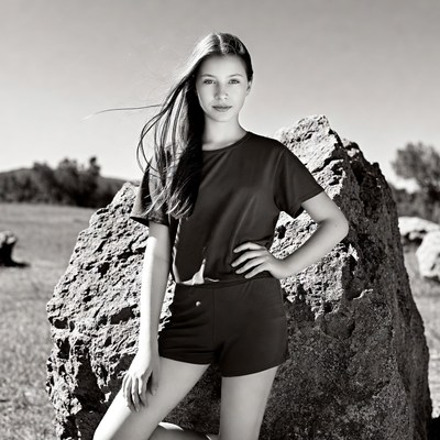 Young woman posing by rocks