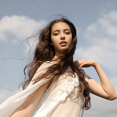 Woman with flowing hair in white dress