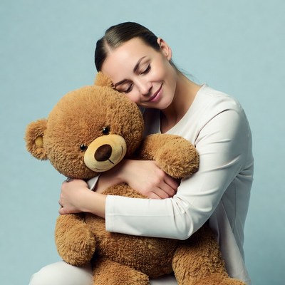 Woman hugging teddy bear