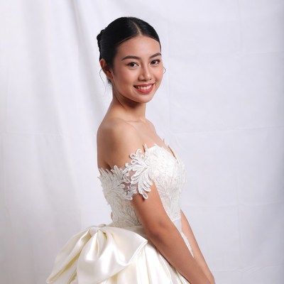 Asian woman in white lace wedding dress