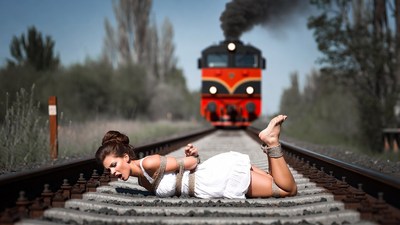 Bound woman on train tracks