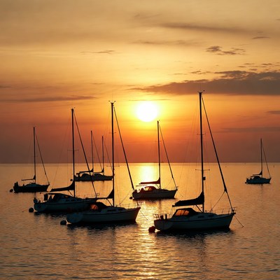 Sailboats at Sunset on Calm Water