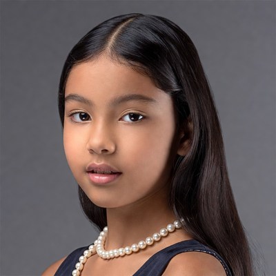 Young Latina girl with pearl necklace