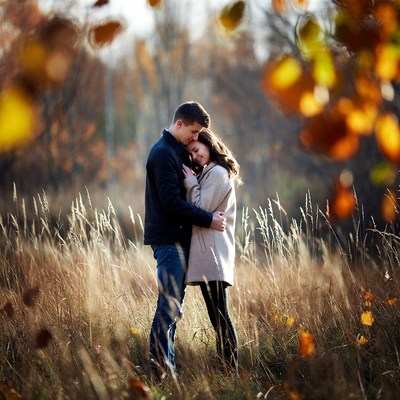 Couple embracing in autumn field