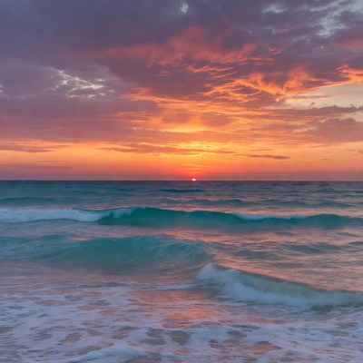 Sunset over turquoise ocean waves