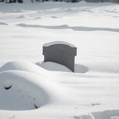 Grave stone in snowy landscape