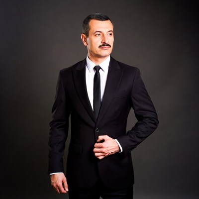 Man in black suit with mustache