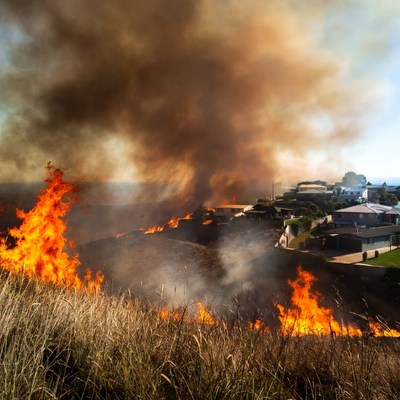Bushfire engulfing hillside houses