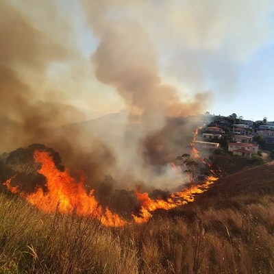 Bushfire engulfing hillside homes