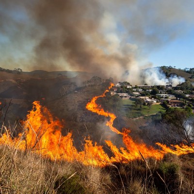 Wildfire Burning Houses on Hillside