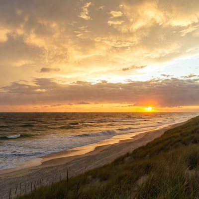 Sunset over beach with dunes
