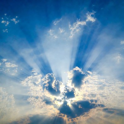 Sun rays beaming through clouds