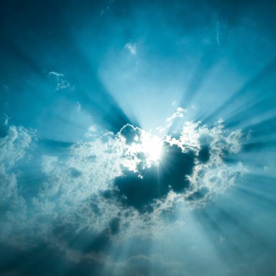 Sun rays through blue clouds