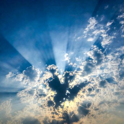 Sun rays beaming through clouds
