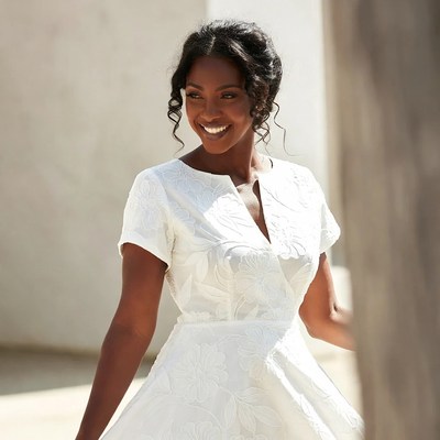 Smiling African-American woman in white dress
