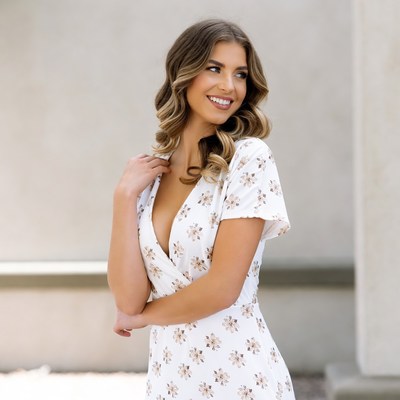 Smiling woman in white floral dress