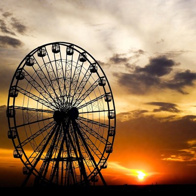 Ferris wheel silhouette at sunset
