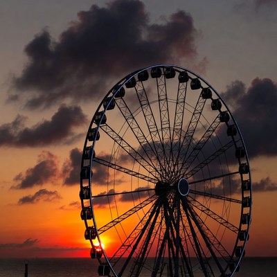 Ferris wheel at sunset over ocean
