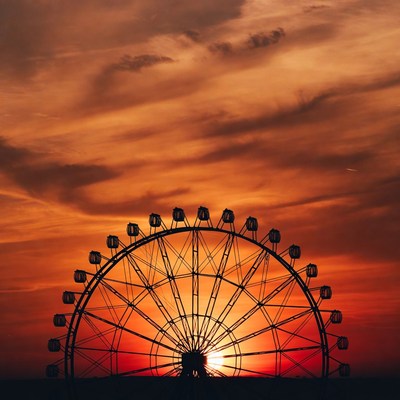Ferris wheel silhouette at sunset