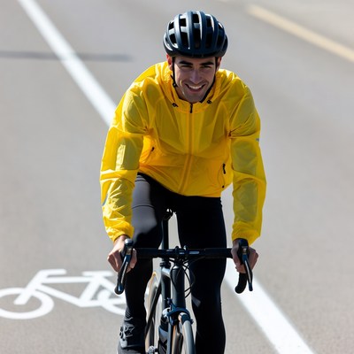 Man cycling in yellow jacket