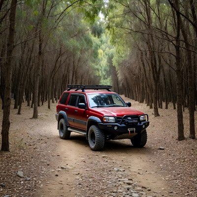 Red off-road SUV in tree-lined trail