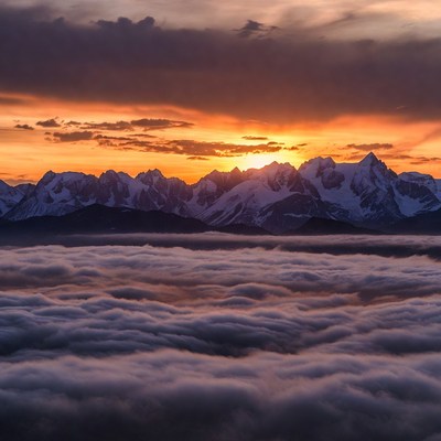 Sunset Over Snowy Mountains Above Clouds