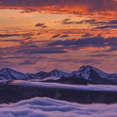 Snowy Mountains in Vibrant Sunset Clouds