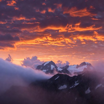 Snowy Mountains at Sunset with Clouds