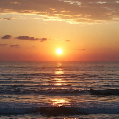 Sunset over ocean with waves