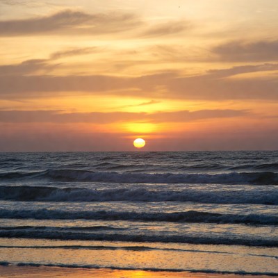 Sunset over ocean waves