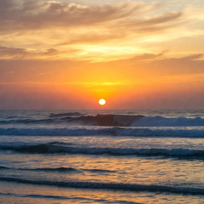 Sunset over ocean waves