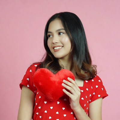 Asian woman holding red heart