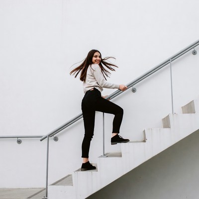 Woman climbing white stairs
