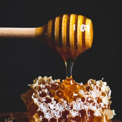Honey Dripping from Wooden Spoon