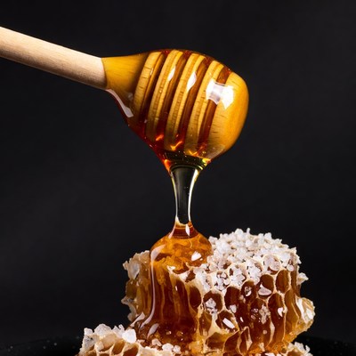 Honey Dripping from Wooden Spoon