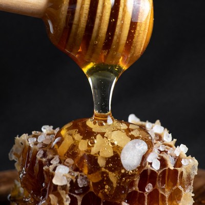 Honey Dripping from Wooden Dipper