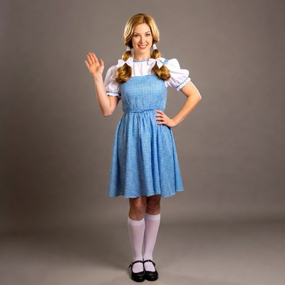 Blonde woman in blue Dorothy costume waving