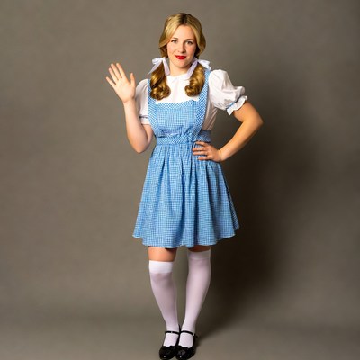 Blonde woman waving in Dorothy costume