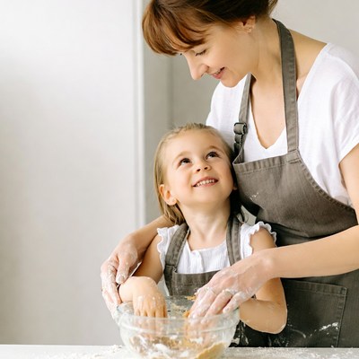 Mother and daughter baking cookies