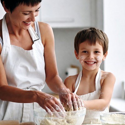 Mother and boy baking dough together