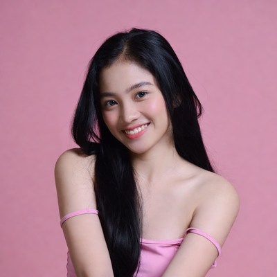 Asian woman smiling on pink background