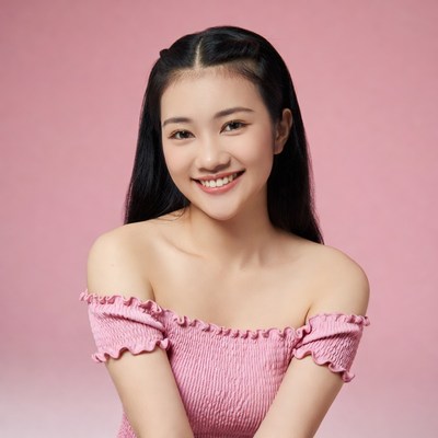 Asian woman smiling in pink off-shoulder dress