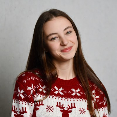 Teen girl smiling in reindeer Christmas sweater