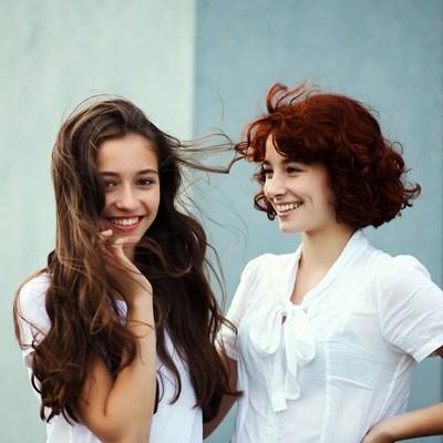 Two women smiling with windy hair